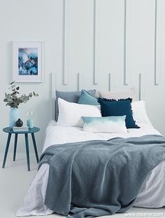 a bedroom with white walls and blue accents