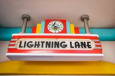 there is a sign that says lightning lane with a clock on the front and bottom