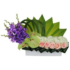 an arrangement of flowers and greenery in a white box on a white background with clippings