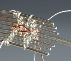 a close up of a metal object with wire wrapped around it's ends and wires