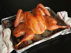 a chicken sitting on top of a pan covered in foil