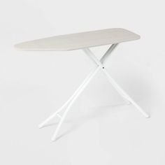 a white ironing board sitting on top of a table