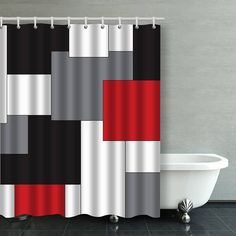 a white bath tub sitting next to a shower curtain with red and black squares on it