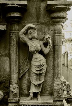 a statue is shown in black and white, with the image of a woman holding an object