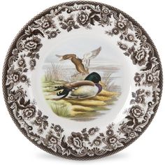 a plate with two ducks on it and flowers around the edges, one is brown