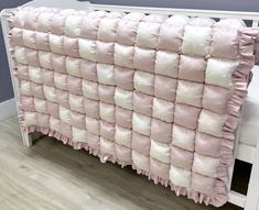 a bed with pink and white pillows on top of it