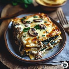 a slice of lasagna on a plate with mushrooms and spinach garnish