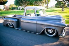 an old pickup truck parked on the side of the road