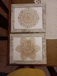 two framed pictures with doily on them sitting next to each other