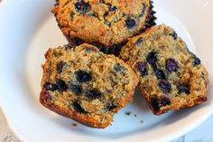 three blueberry muffins on a white plate