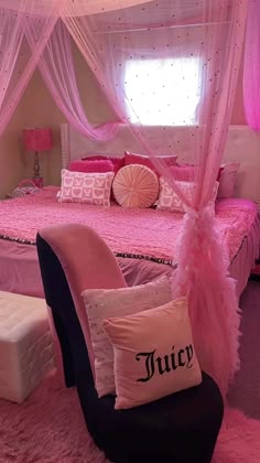 a bedroom with pink bedding and pillows