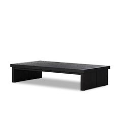 a black coffee table sitting on top of a white floor