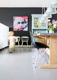 a white painted floor for looks amazing against black and gray walls in this modern kitchen