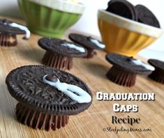 graduation caps made out of oreo cookies on a wooden table with bowls and spoons in the background