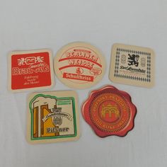 four different types of beer coasters on a white surface