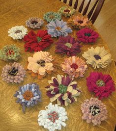 a bunch of flowers sitting on top of a wooden table