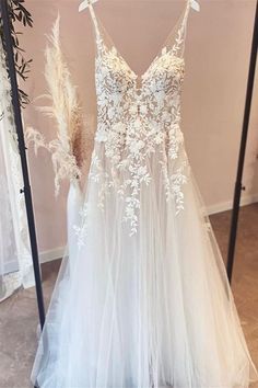 a white wedding dress hanging on a rack