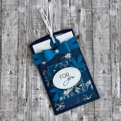 a tag that says for you on it with blue ribbon hanging from the front and side