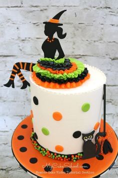 a decorated halloween cake sitting on top of a table