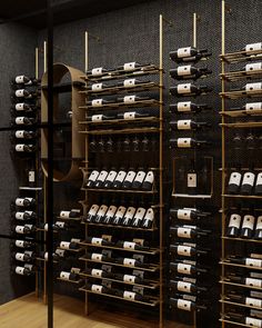 the wine rack is full of many bottles and glasses in it's display case