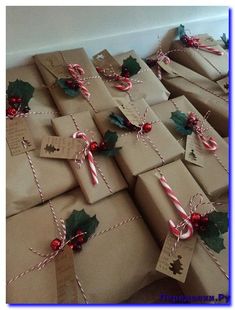 many wrapped presents with candy canes and holly leaves on them, all tied up in twine