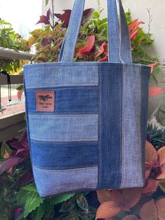 a blue tote bag sitting on top of a planter