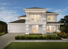 a white two story house with lots of windows and grass in front of the house