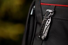 there is a small tool in the pocket of a backpack that's attached to it