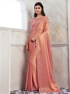 Introducing our exquisite Peach Shimmer Silk Saree, a masterpiece that exudes elegance and sophistication. This saree, meticulously crafted from the finest silk, is adorned with delicate sequin and intricate embroidered work, making it a perfect choice for any grand celebration. The peach hue of the saree lends a soft, feminine touch, while the shimmer adds a subtle, glamorous sheen, ensuring you stand out at any event. Measuring 6.30 meters in length, this saree drapes beautifully, enhancing yo Peach Color Saree, Peach Saree, Kurti Designs Latest, Party Sarees, Party Wear Saree, Satin Saree, Half Sleeve Blouse, Party Wear Lehenga, Trendy Sarees