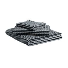 black and white towels stacked on top of each other