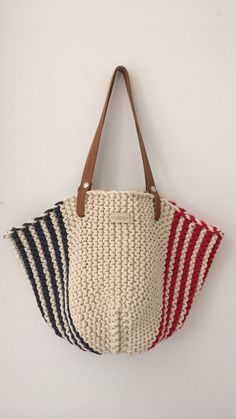 three bags hanging on the wall with one in red, white and blue striped fabric