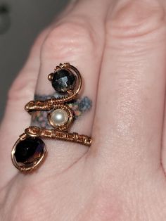 a woman's hand with two rings on top of her finger, and an amethyst ring in the middle