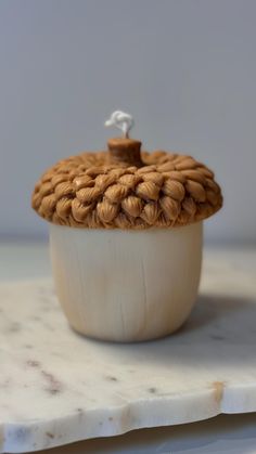 a white bowl with some kind of thing in it's lid on a table