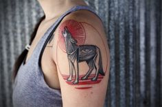 a woman with a wolf tattoo on her arm