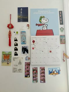 a refrigerator with magnets and pictures on the fridge's side, including a calendar