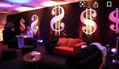 a room with couches, tables and lights on the walls that have dollar signs painted on them