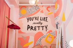 there is a pink and yellow wall in this room with the words you're like, really pretty on it