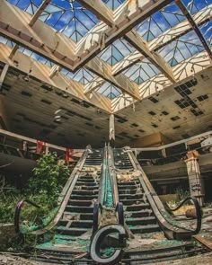 an abandoned building with stairs leading up to the ceiling and skylights above it,