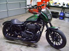 a green motorcycle parked in a garage