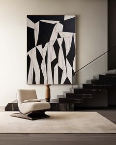 a chair sitting on top of a rug next to a stair case in a living room