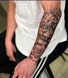 a man with a tiger and rose tattoo on his arm