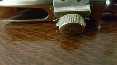 a close up view of a metal object on a wooden table