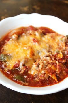 a white bowl filled with chili and cheese