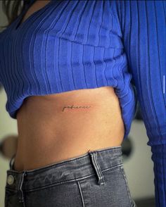 a woman with a small tattoo on her stomach