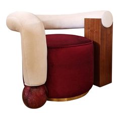 a red chair with a white back and arm rests on a wooden block next to an apple