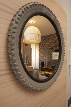 a round mirror hanging on the side of a wall