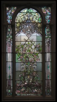 a stained glass window with flowers and vines