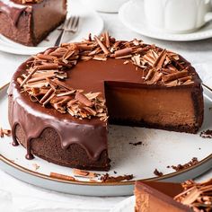 a chocolate cheesecake on a plate with one slice cut out