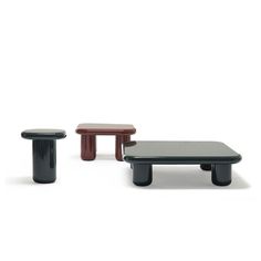 three small tables and stools are shown in different colors, shapes and sizes on a white background