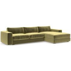 a green sectional couch sitting on top of a white floor